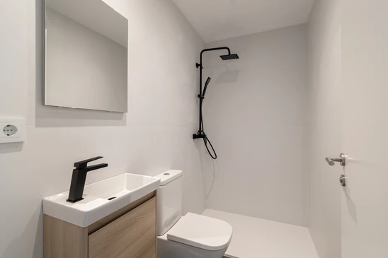 Salle de bain moderne avec douche &agrave; l'italienne, carrelage m&eacute;tro blanc, sol en carreaux de ciment motifs g&eacute;om&eacute;triques